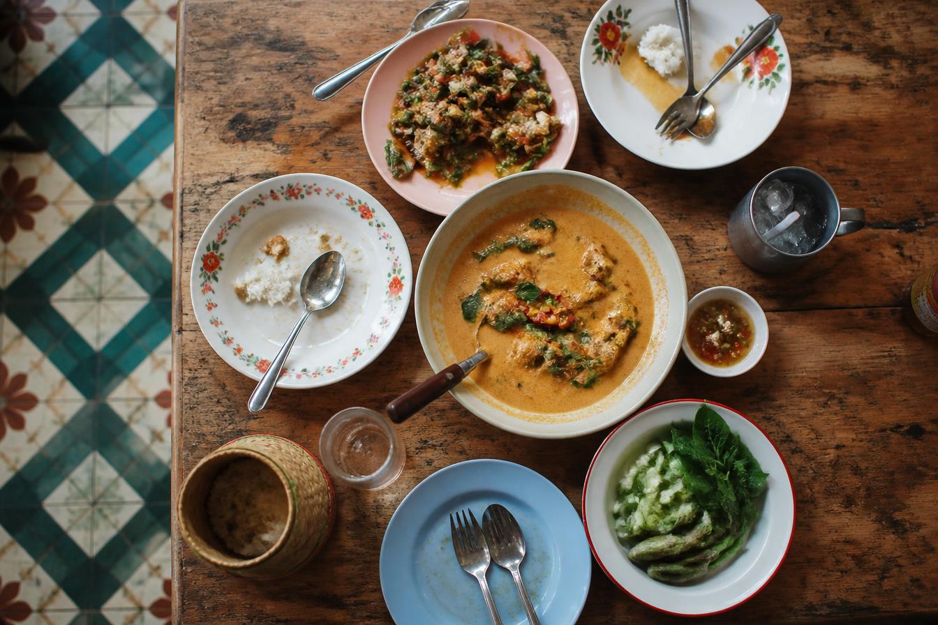 Shared plates of regional food on a worn wooden restaurant table
