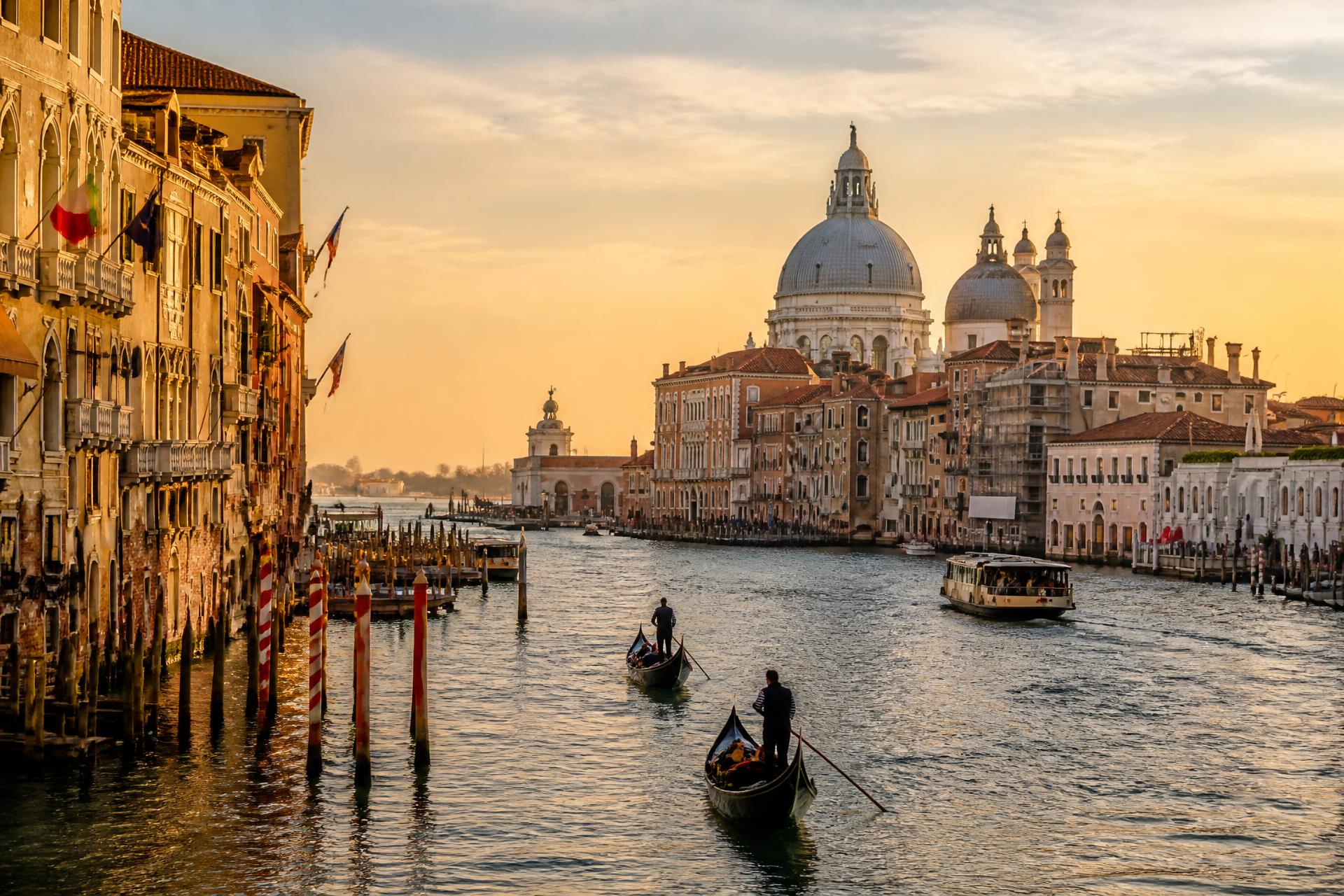 Gondolas on the Grand Canal at golden hour in Venice, Italy